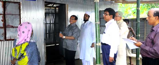 Adviser of Grihayan Tahobil inspets a house built by NGO
